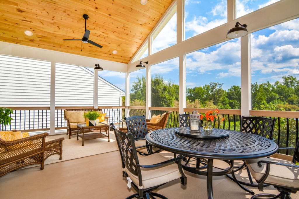 Covered porch designed for comfortable outdoor living spaces with scenic backyard views
