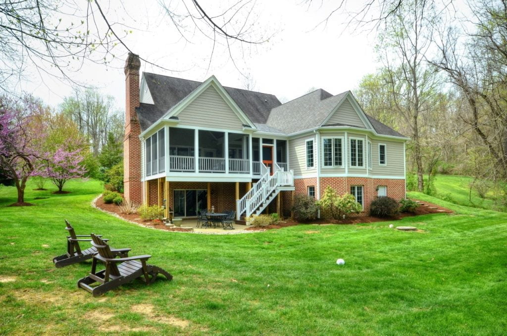 home construction project using sustainable building methods, with a large backyard porch and screened-in porch